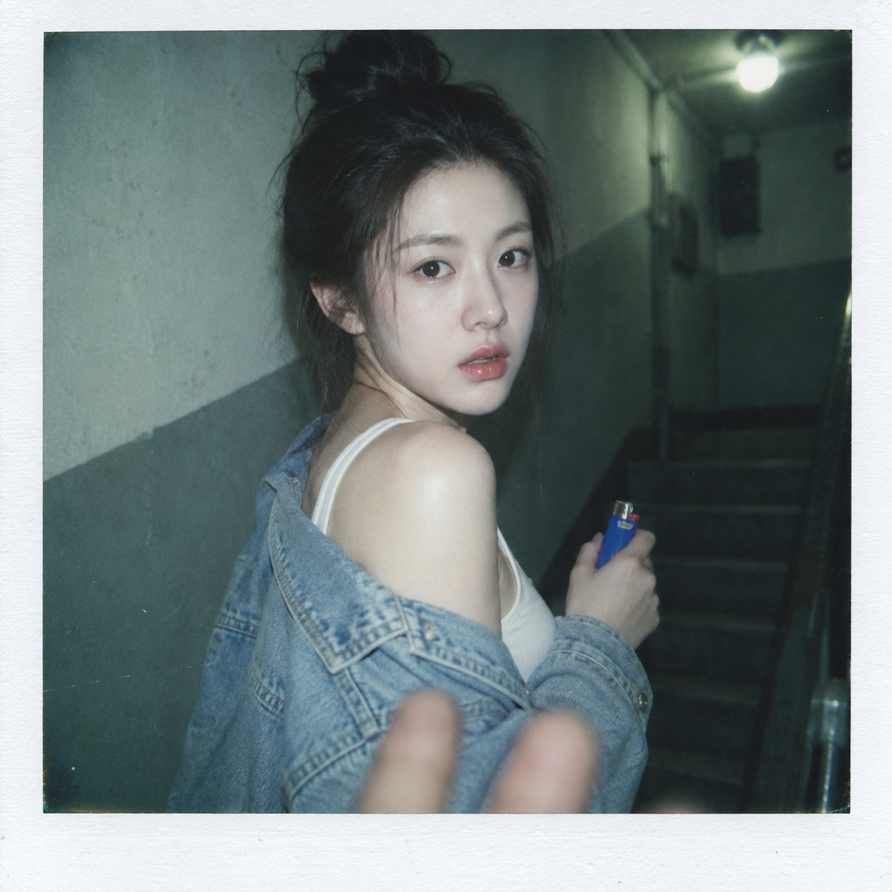 Polaroid snapshot of a Korean-style girl in a dim stairwell